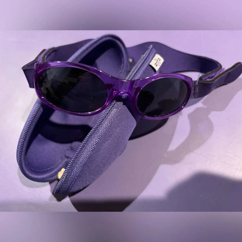 Baby sunglasses. Approx Sz 6-18 months. Velcro is adjustable. Comes with case.